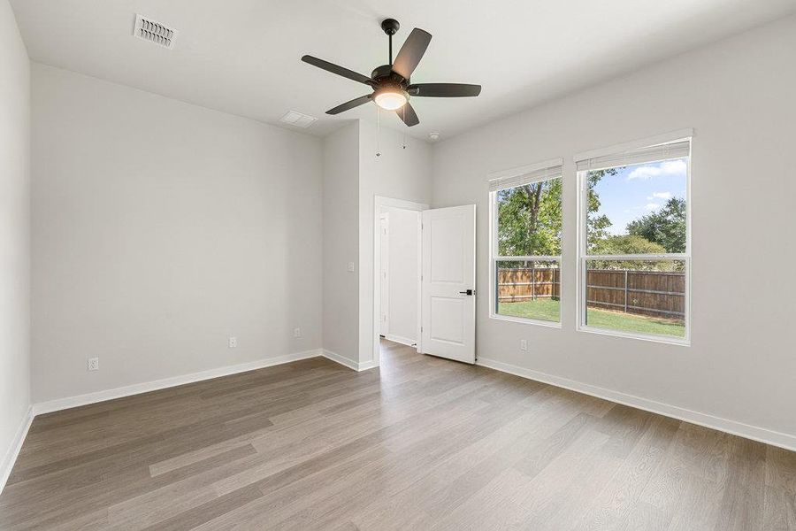 Unfurnished room with light wood-style floors and ceiling fan