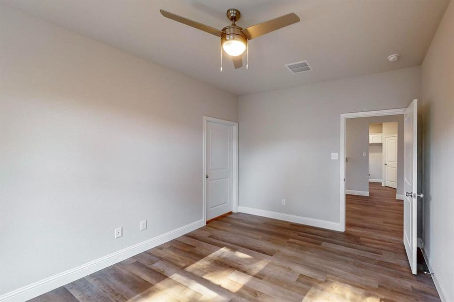 Unfurnished bedroom with light wood-type flooring and ceiling fan