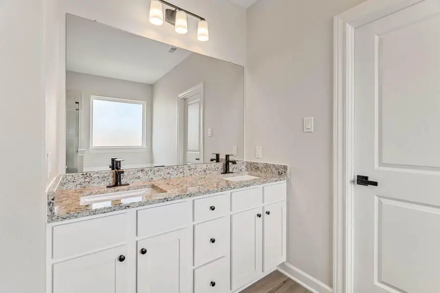 The primary bathroom is fitted with double-sinks.