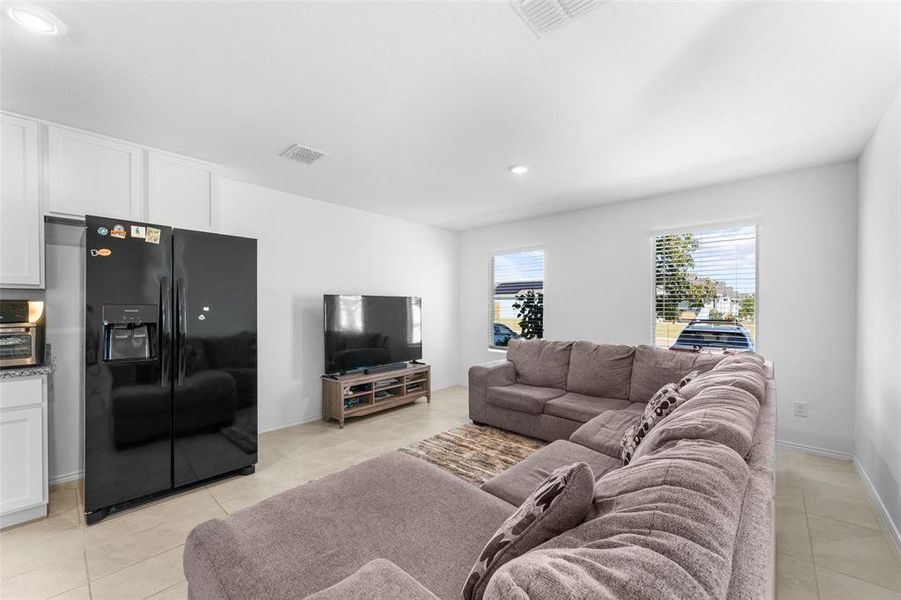 Living area featuring recessed lighting and light tile patterned flooring Living area featuring recessed lighting and light tile patterned flooring