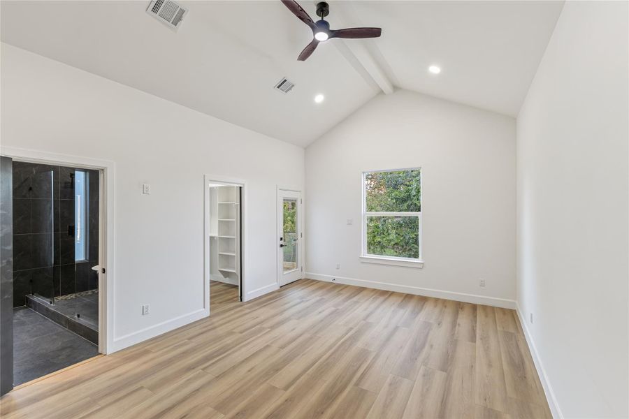 Primary Bedroom with walk in closet, leading on to balcony.