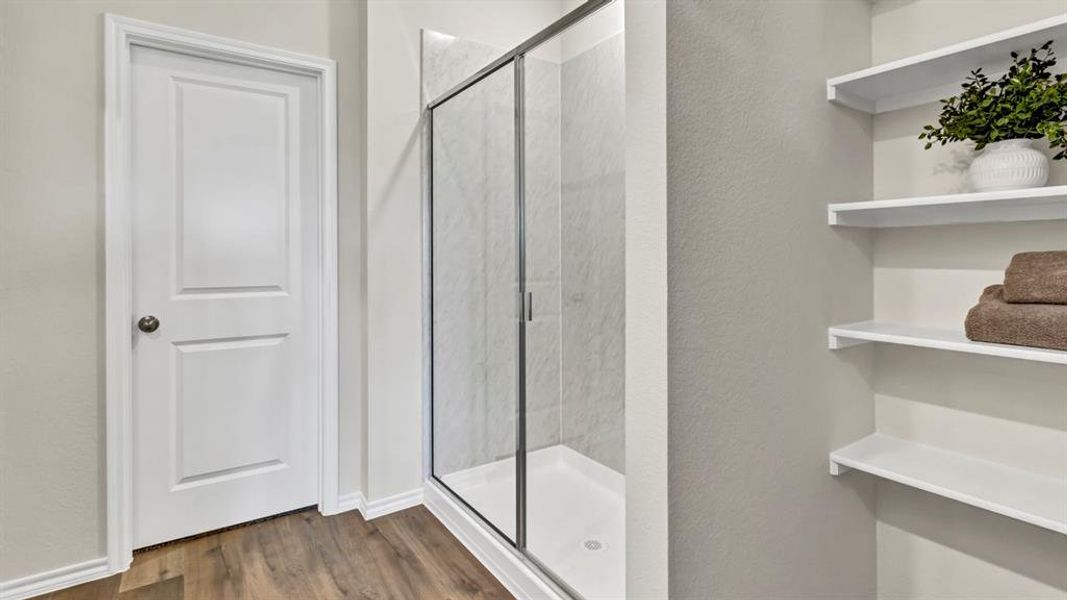 Walk-in shower with clear glass enclosure and tile surround Walk-in shower with clear glass enclosure and tile surround