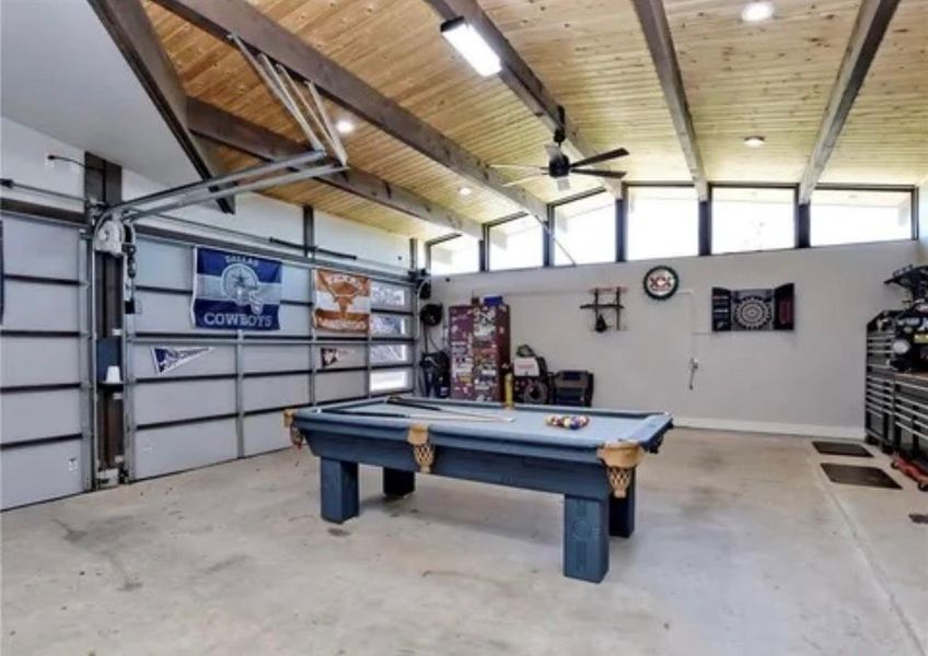 Playroom featuring a garage, concrete flooring, pool table, ceiling fan, and wooden ceiling Playroom featuring a garage, concrete flooring, pool table, ceiling fan, and wooden ceiling