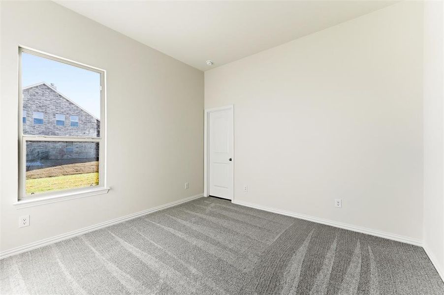 Unfurnished room with carpet flooring and baseboards
