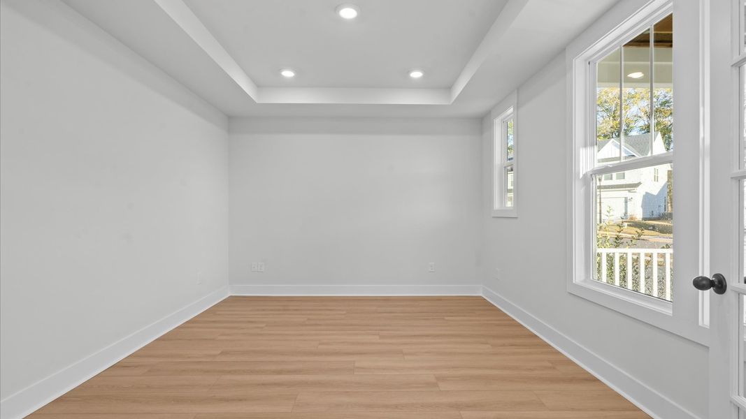 Vibrant natural light and tasteful design define this French door study near the front of the home