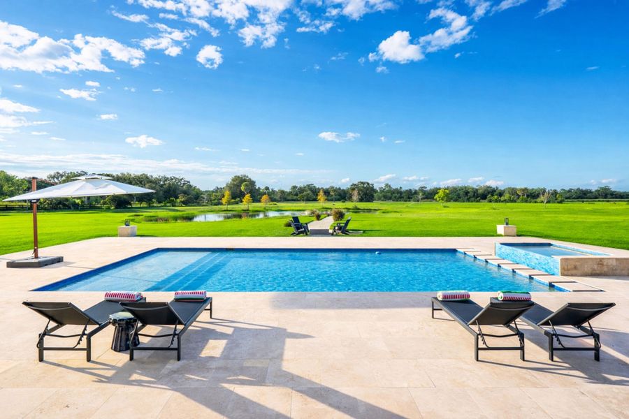 Sunny poolside retreat with lush landsca