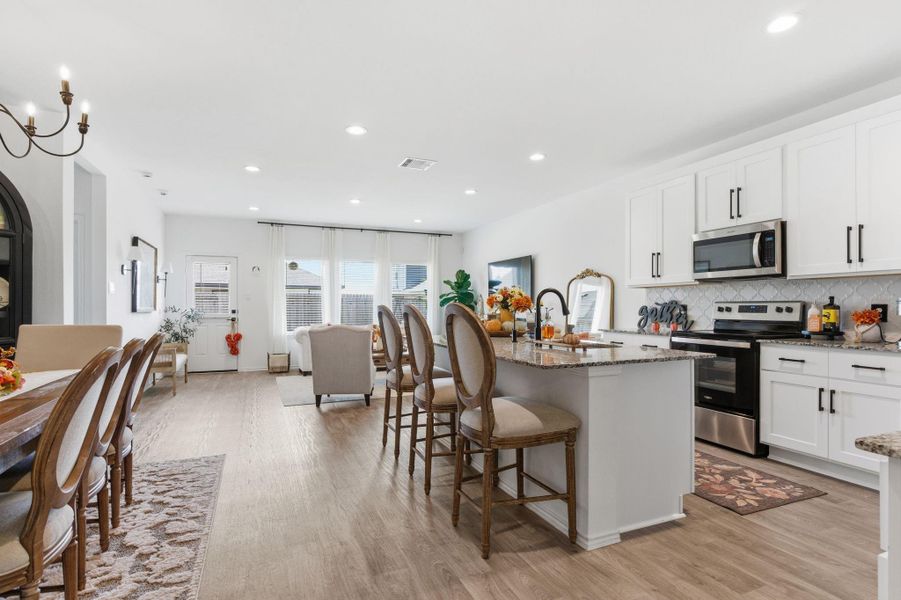 Gourmet kitchen featuring granite countertops, stainless steel appliances, and a large eat-in island. Gourmet kitchen featuring granite countertops, stainless steel appliances, and a large eat-in island.