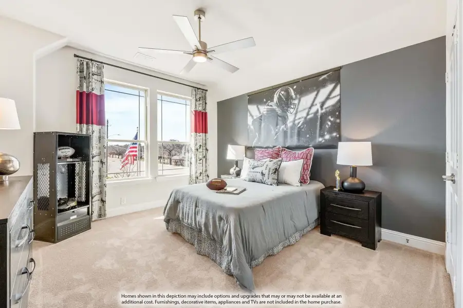 Bedroom with gray accent wall, ceiling fan, sports-themed decor, and carpet flooring