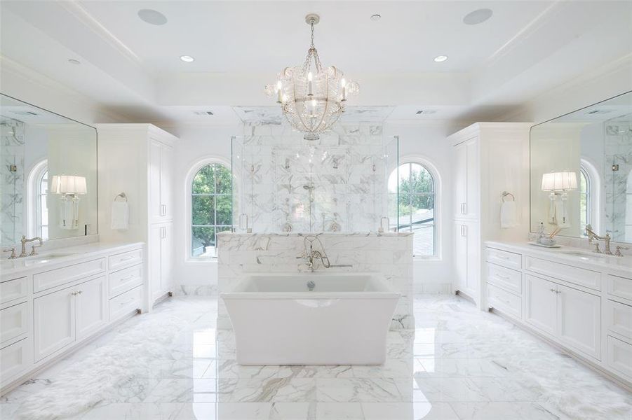 Bathroom featuring tile patterned floors, plenty of natural light, and double vanity