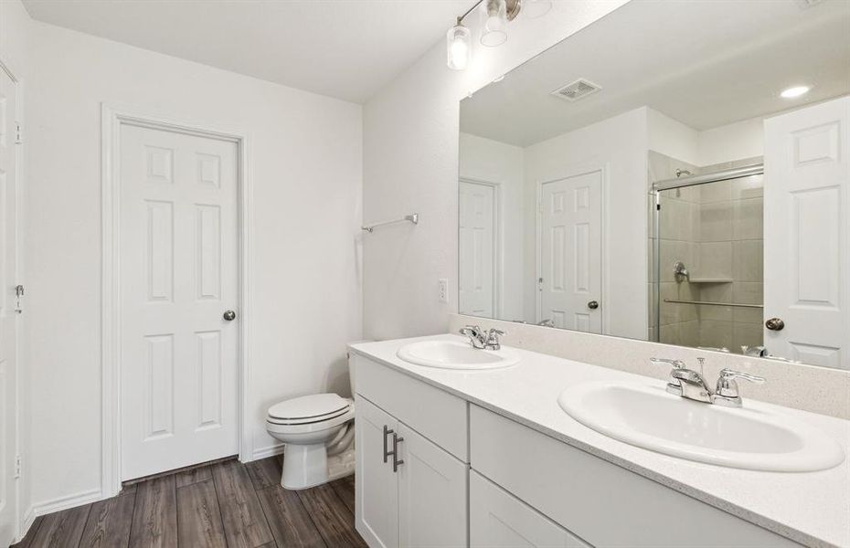 Upgraded secondary bath with double vanity *real home pictured