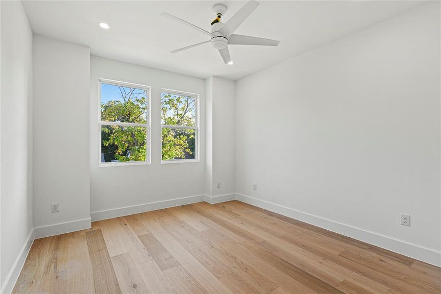 Unfurnished room featuring light wood-style flooring, recessed lighting, and a ceiling fan