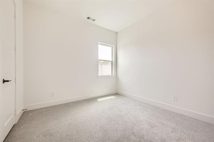 Unfurnished room featuring light colored carpet and baseboards