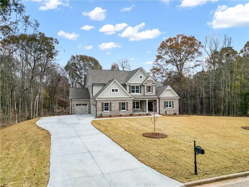 Front exterior of a new home in Ella Springs, Covington, GA, highlighting curb appeal (Image 2).