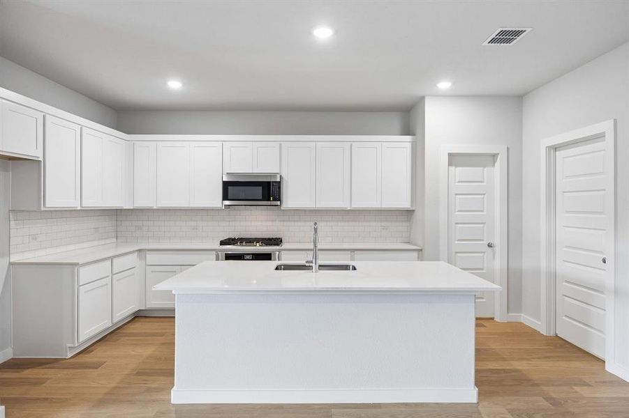 Kitchen in the Oscar home plan by Trophy Signature Homes – REPRESENTATIVE PHOTO Kitchen in the Oscar home plan by Trophy Signature Homes – REPRESENTATIVE PHOTO