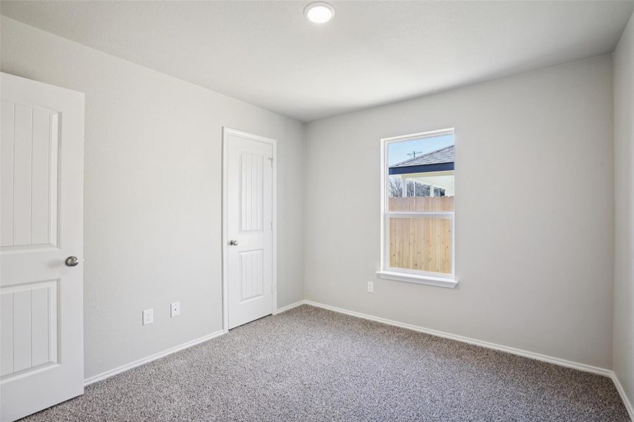 Unfurnished bedroom with carpet flooring and a closet