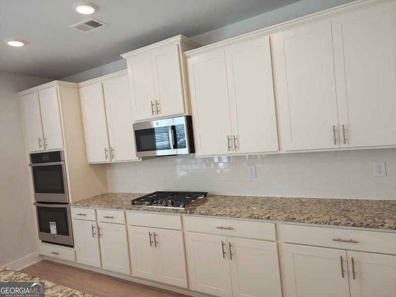 Furnished interior view inside a new home in The Fairways at Mirror Lake, Villa Rica (Image 6).
