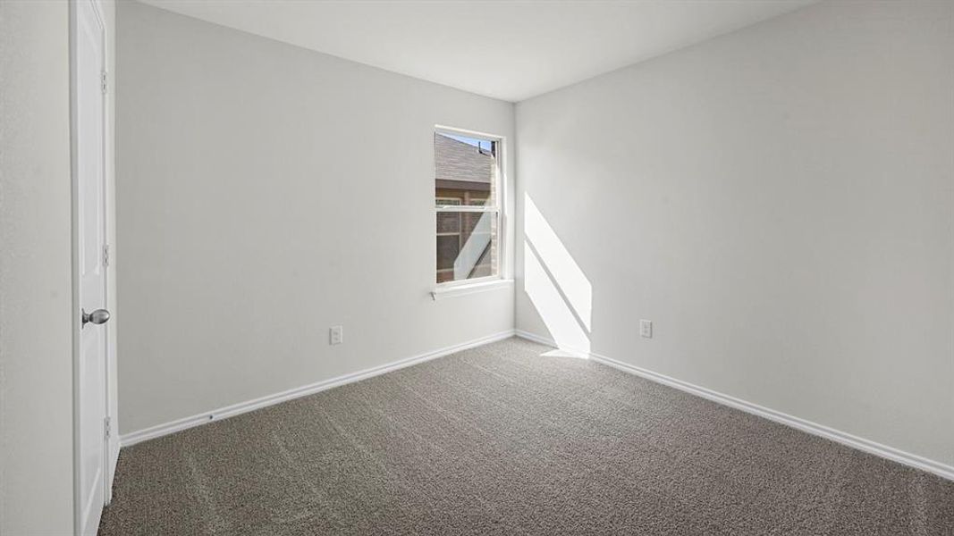 Empty room featuring baseboards and carpet floors