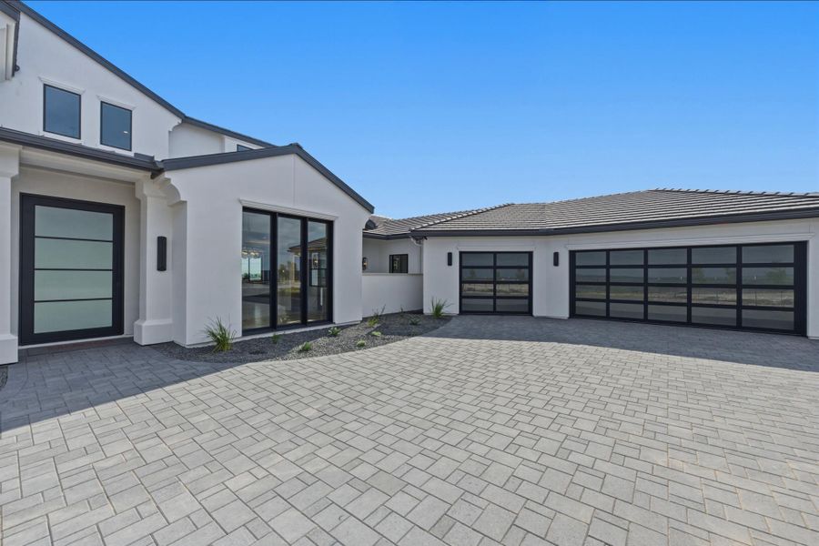 3 car garage, courtyard, wall of windows into dining room.