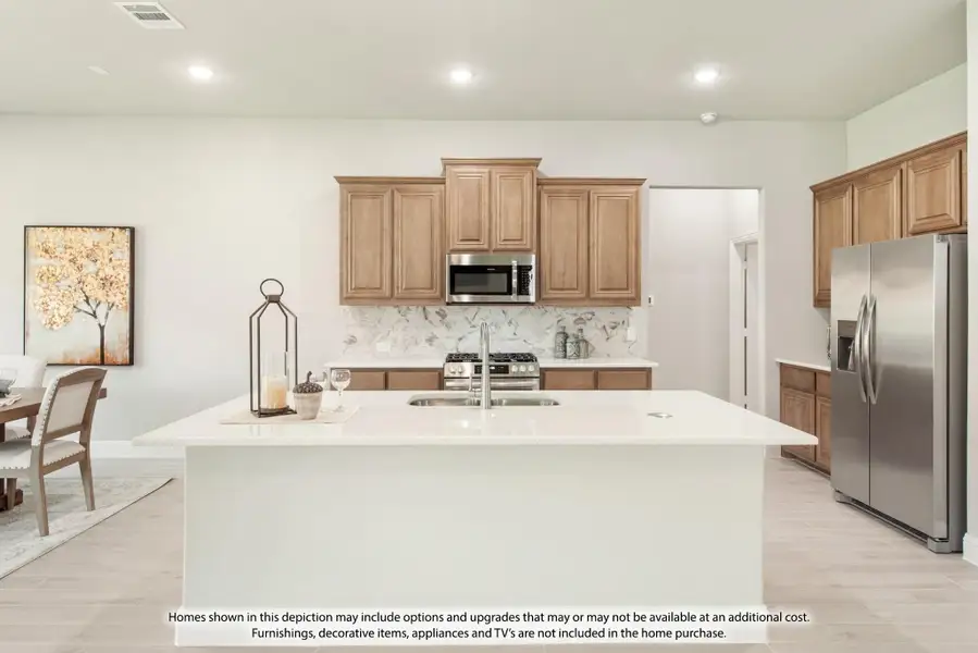 Kitchen with large white island, wood cabinets, marble backsplash, and stainless steel appliances Kitchen with large white island, wood cabinets, marble backsplash, and stainless steel appliances