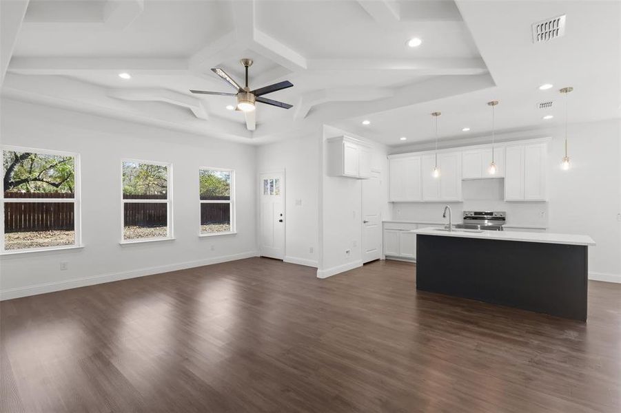 Kitchen with pendant lighting, dark hardwood / wood-style floors, and white cabinets