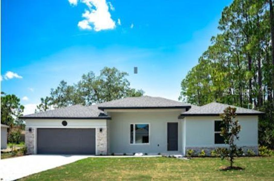 Front exterior of a new home in Palm Coast, Palm Coast, FL, highlighting curb appeal (Image 1). Front exterior of a new home in Palm Coast, Palm Coast, FL, highlighting curb appeal (Image 1).