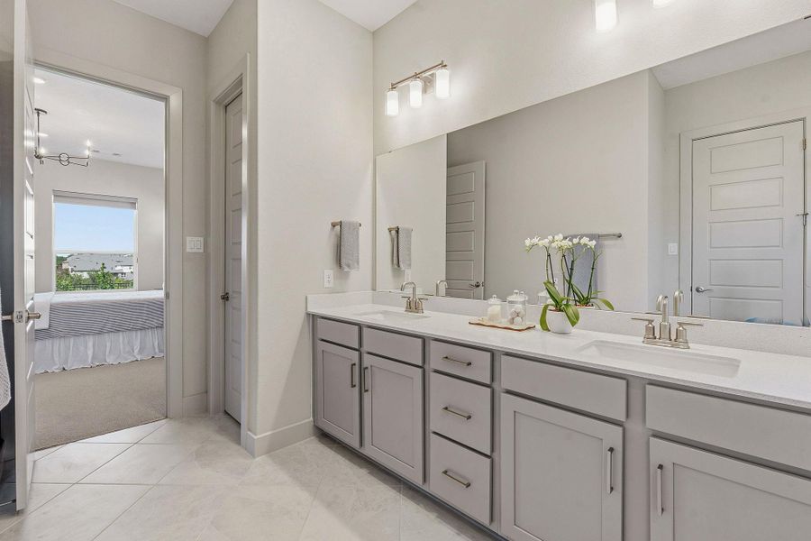 Ensuite bathroom featuring double vanity and a closet Ensuite bathroom featuring double vanity and a closet