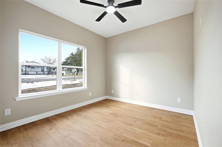 Unfurnished room with light wood-style floors and ceiling fan Unfurnished room with light wood-style floors and ceiling fan
