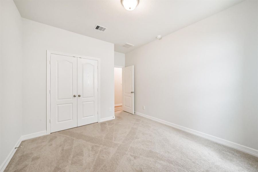 A reach in closet enclosed by double doors offers convenient storage for clothing and everyday essentials. A reach in closet enclosed by double doors offers convenient storage for clothing and everyday essentials.