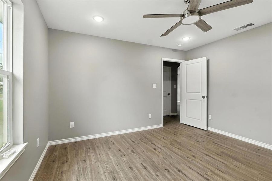 Spare room featuring light wood finished floors, ceiling fan, and recessed lighting Spare room featuring light wood finished floors, ceiling fan, and recessed lighting