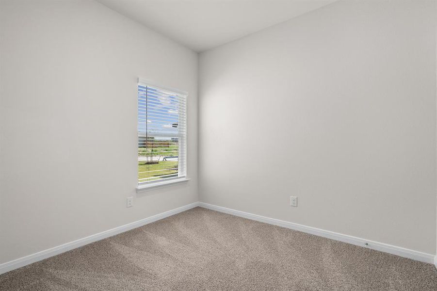 Carpeted empty room with baseboards