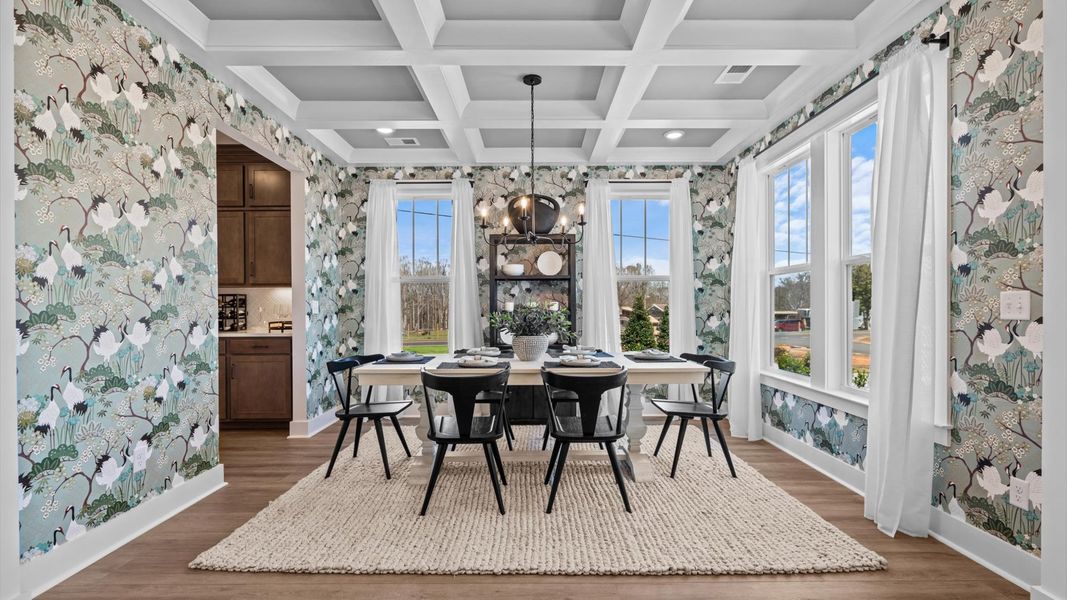 Desirable dining room with coffered ceiling and modern elegance in an established community