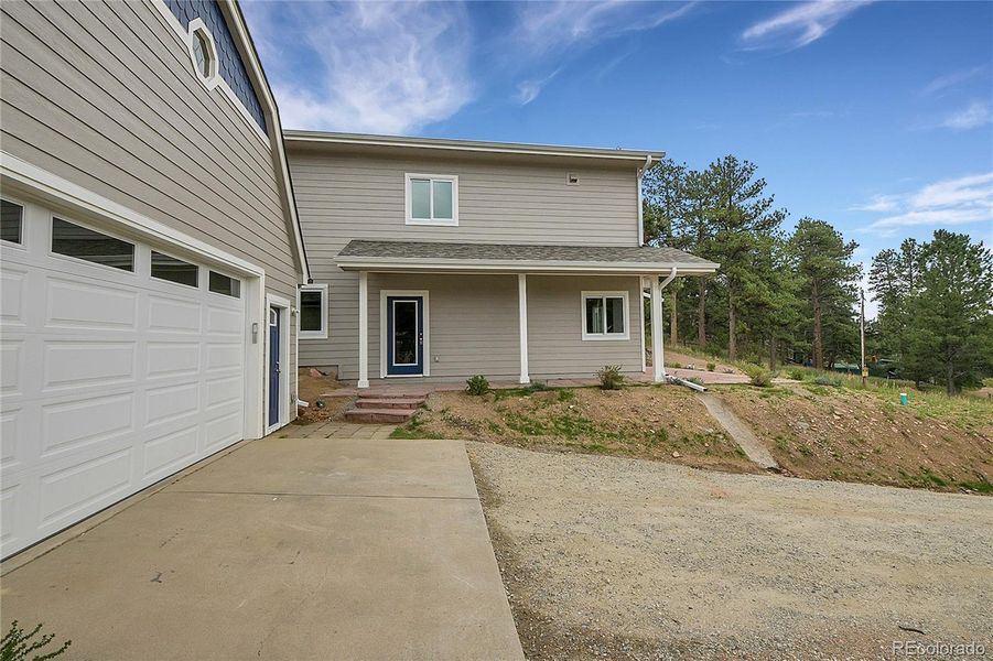 Front exterior of a new home in , Pine, CO, highlighting curb appeal (Image 18).