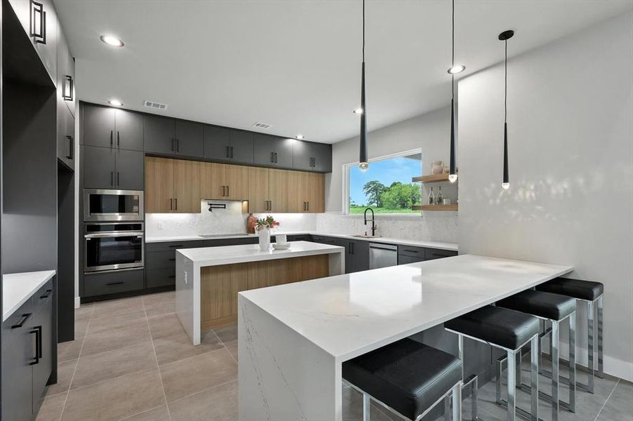 Kitchen featuring appliances with stainless steel finishes, tasteful backsplash, a kitchen island, modern cabinets, and recessed lighting