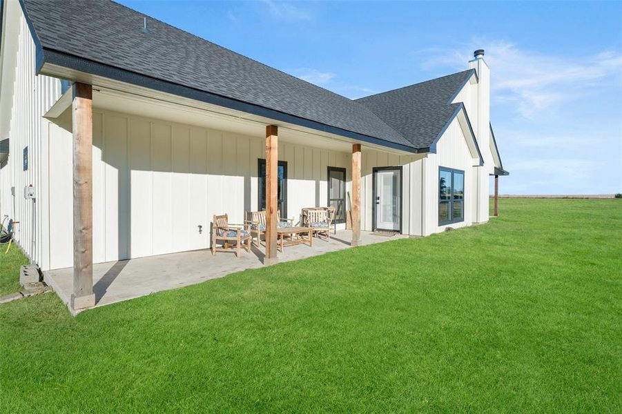 Rear view of property featuring a patio area and a yard