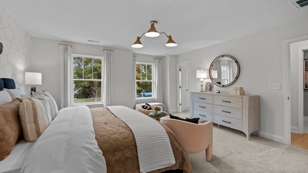 Spacious owner's suite with large windows and plush carpeting in the new Adaline Design by DRB Homes Charlotte, NC