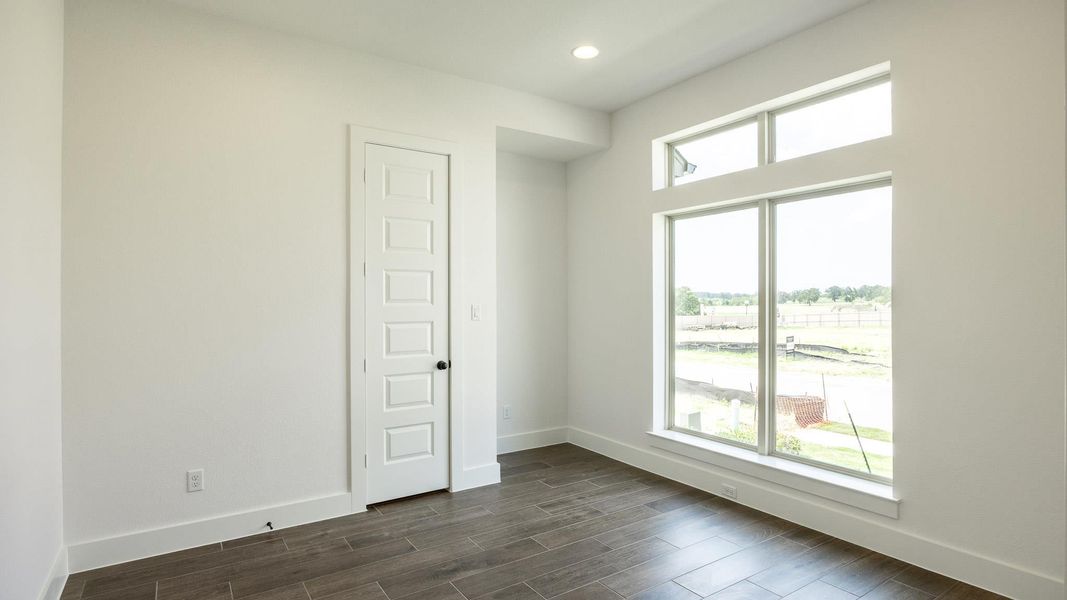 Unfurnished room featuring baseboards, dark wood-style flooring, and recessed lighting
