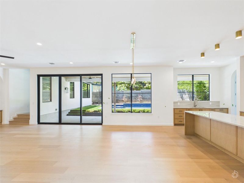 Hardwood floors and multi-slide doors open this great room to the backyard and pool.