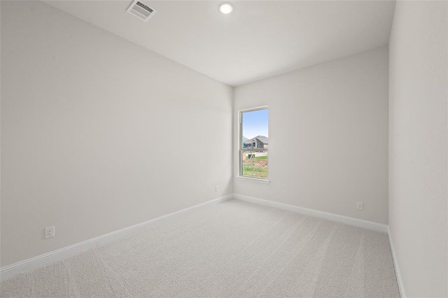 Spare room with light colored carpet and recessed lighting