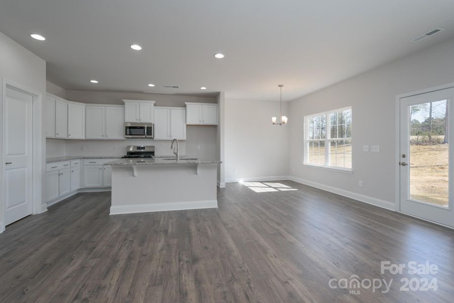 Family Room into Kitchen/Breakfast Room. Photo representation. Colors and options will differ.