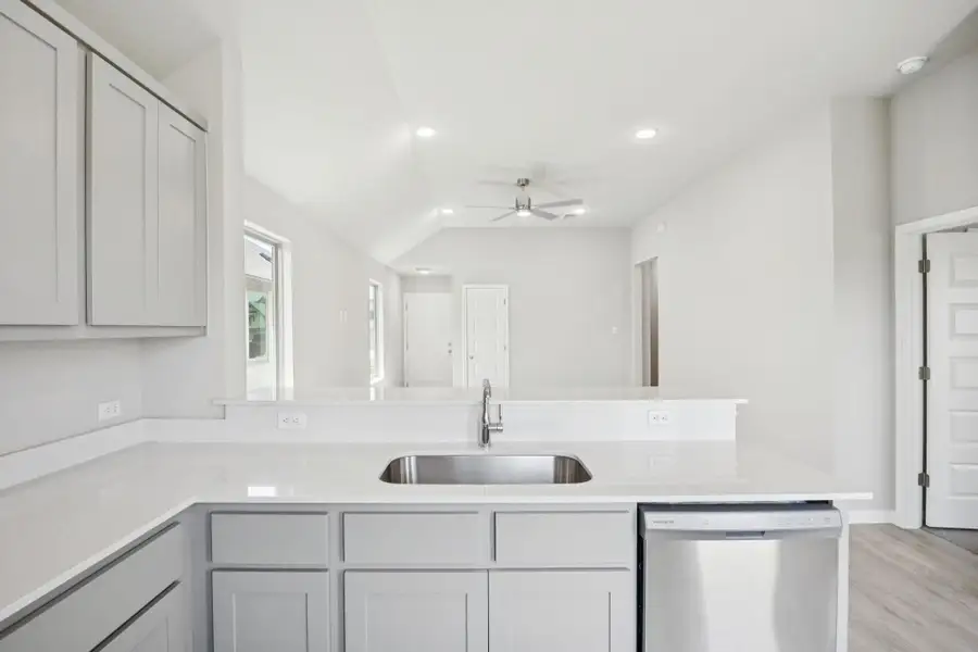 Kitchen featuring a ceiling fan, dishwasher, light wood finished floors, a peninsula, and recessed lighting
