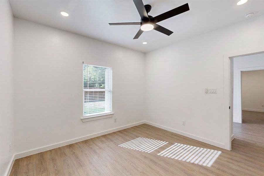 Unfurnished room with ceiling fan and light hardwood / wood-style floors