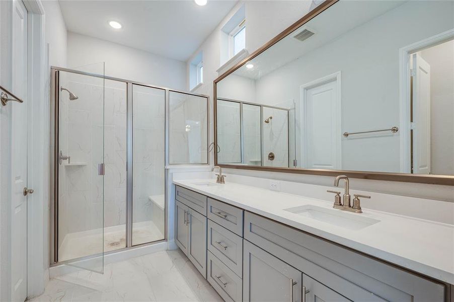 Beautiful Primary Bathroom with large shower & quartz counters with on trend gold fixtures.