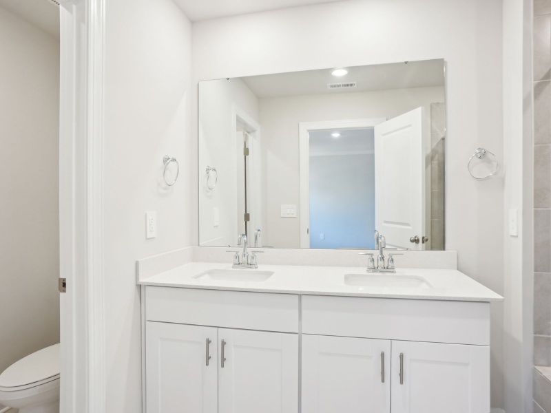 The primary bathroom conveniently connects to the bedroom for privacy and comfort.