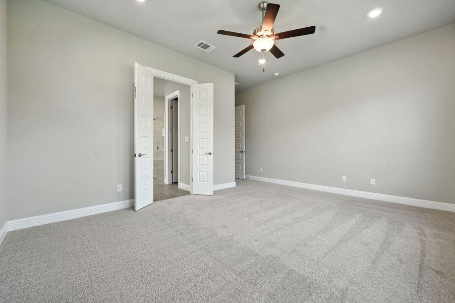 Unfurnished bedroom featuring light carpet, recessed lighting, and ceiling fan