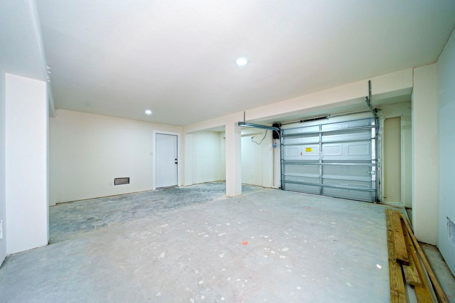 Spacious garage with ample room for vehicles and storage. Spacious garage with ample room for vehicles and storage.