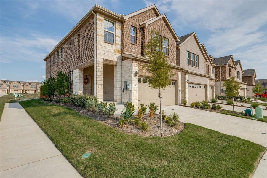 View of front of house with a residential view, stone siding, a front lawn, and driveway View of front of house with a residential view, stone siding, a front lawn, and driveway