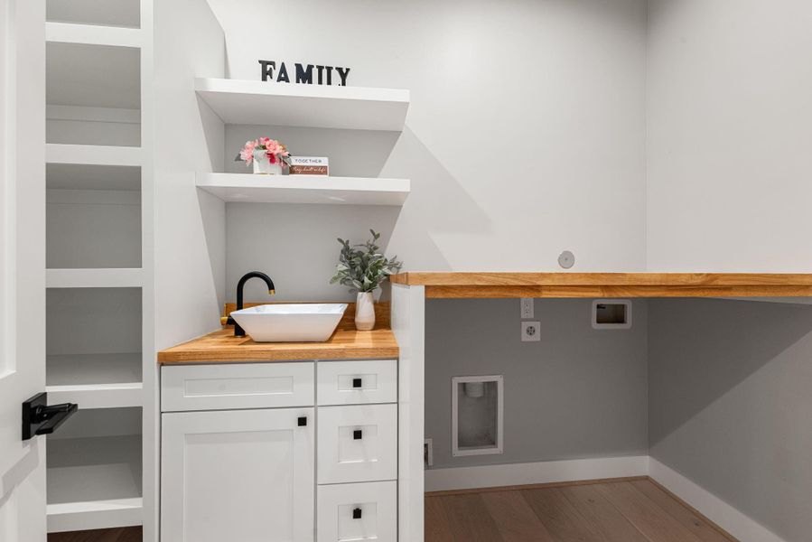 Laundry room with built-in sink and shelves Laundry room with built-in sink and shelves