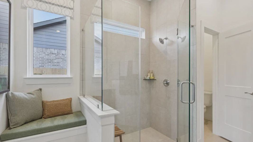 Representative furnished interior of a home built from the Adele by Chesmar Homes in Sunterra, Katy (Image 17).