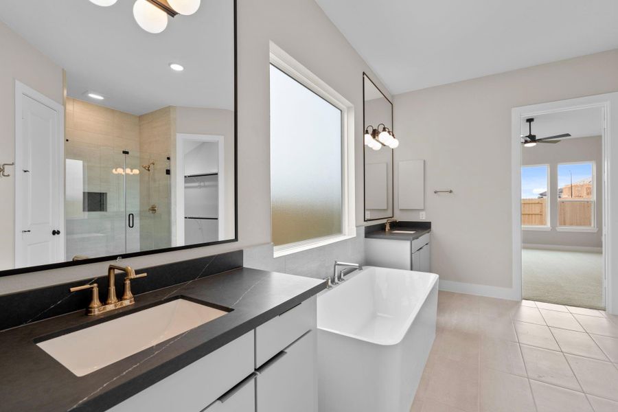 The main suite is beautifully appointed with high-end finishes and a soaker tub