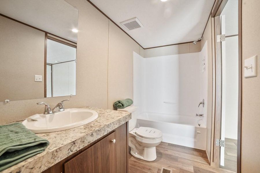 Bathroom with vanity, bathtub / shower combination
